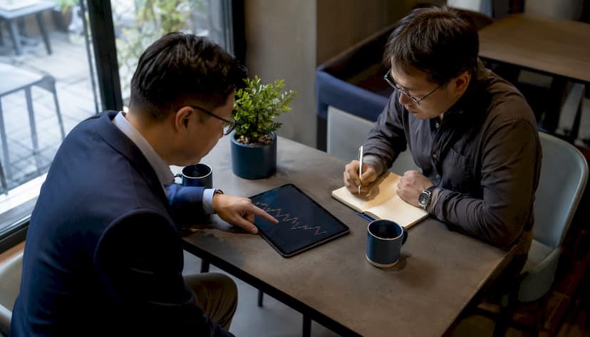 Businessmen discussing market cap reports